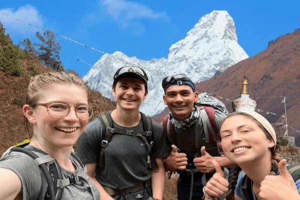 Happy-trekkers-posing-with-Ama-Dablam-during-the-Everest-Base-Camp-Trek