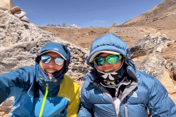 two-trekkers-smiling-on-the-way-to-three-pass-trek